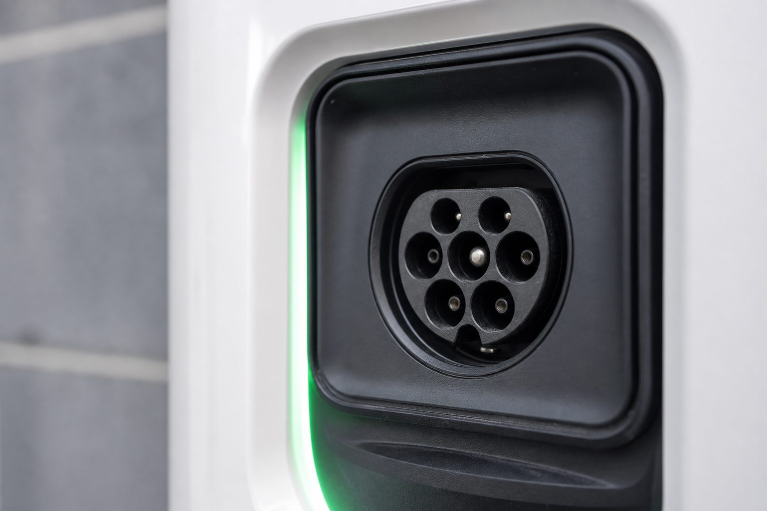 Close detail of ground-post EV charger and cable management holster